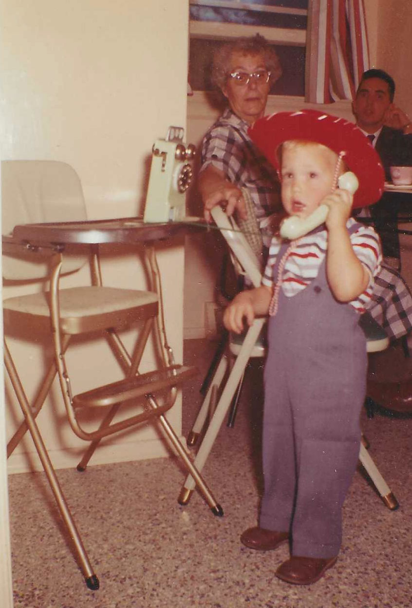Boyd as a child with a toy telephone